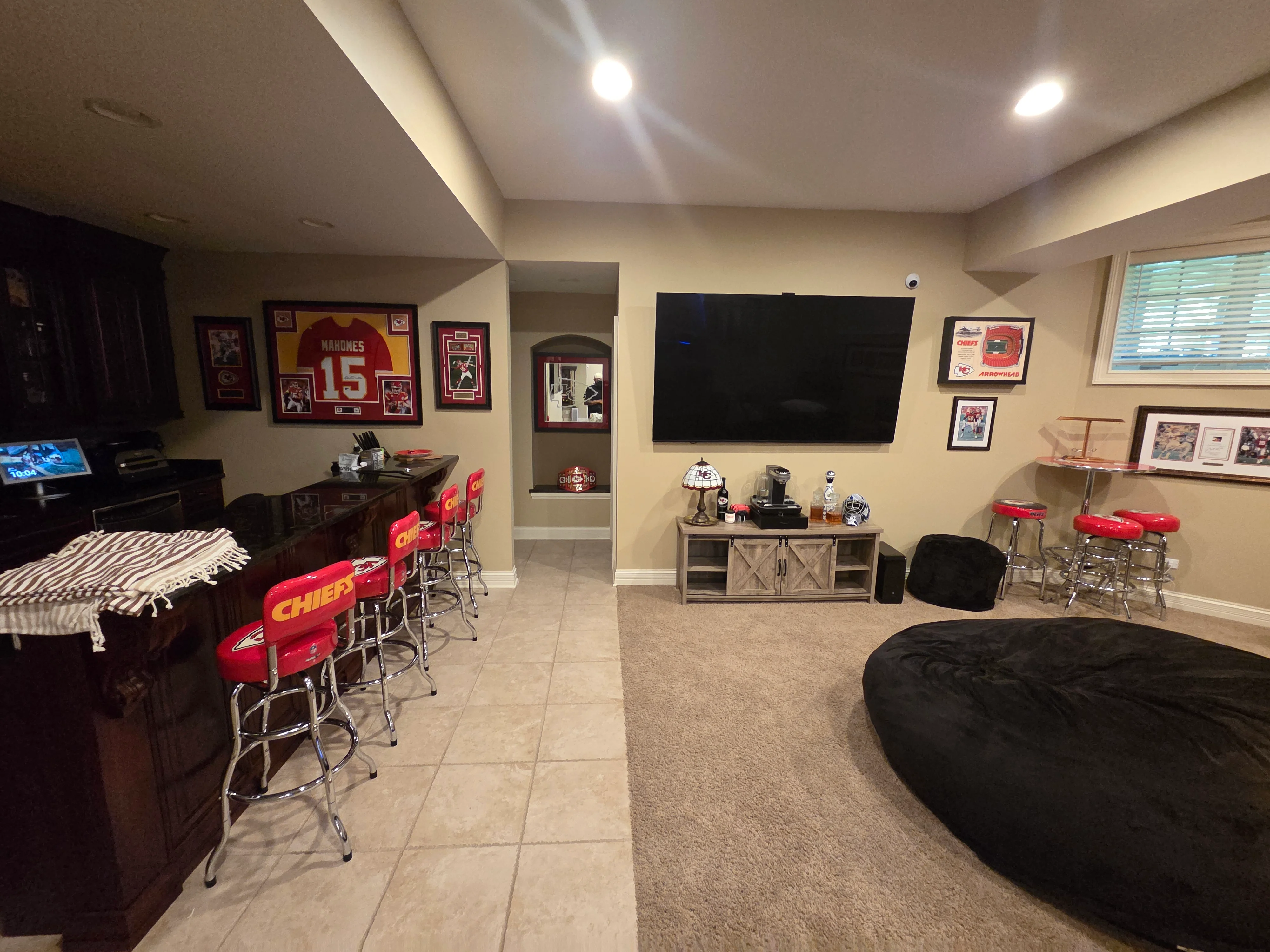 Finished basement with cream painted walls, recessed lighting, and painted drywall ceiling