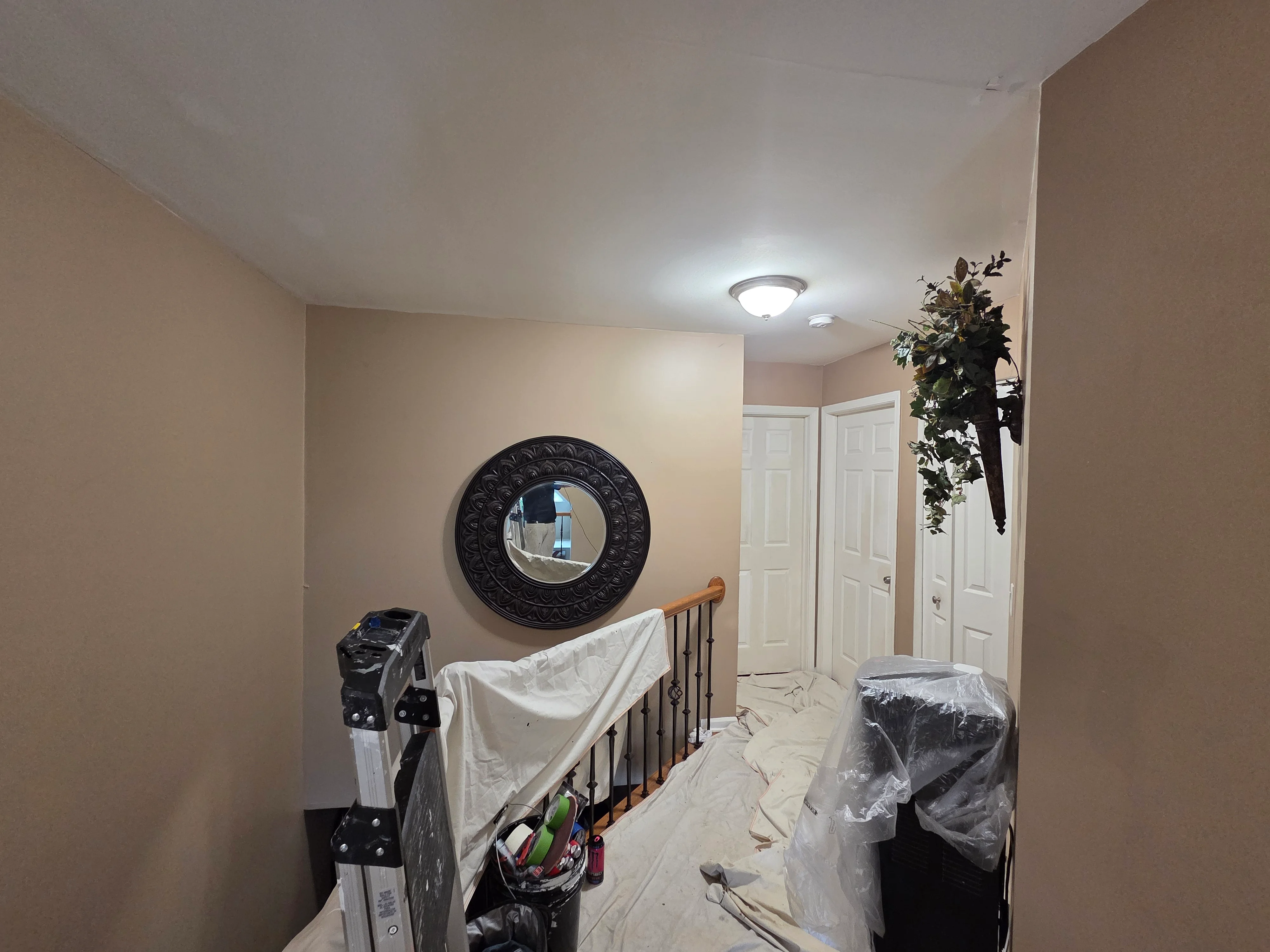 Hallway with neutral painted walls, white ceiling, recessed lighting, and white six-panel doors