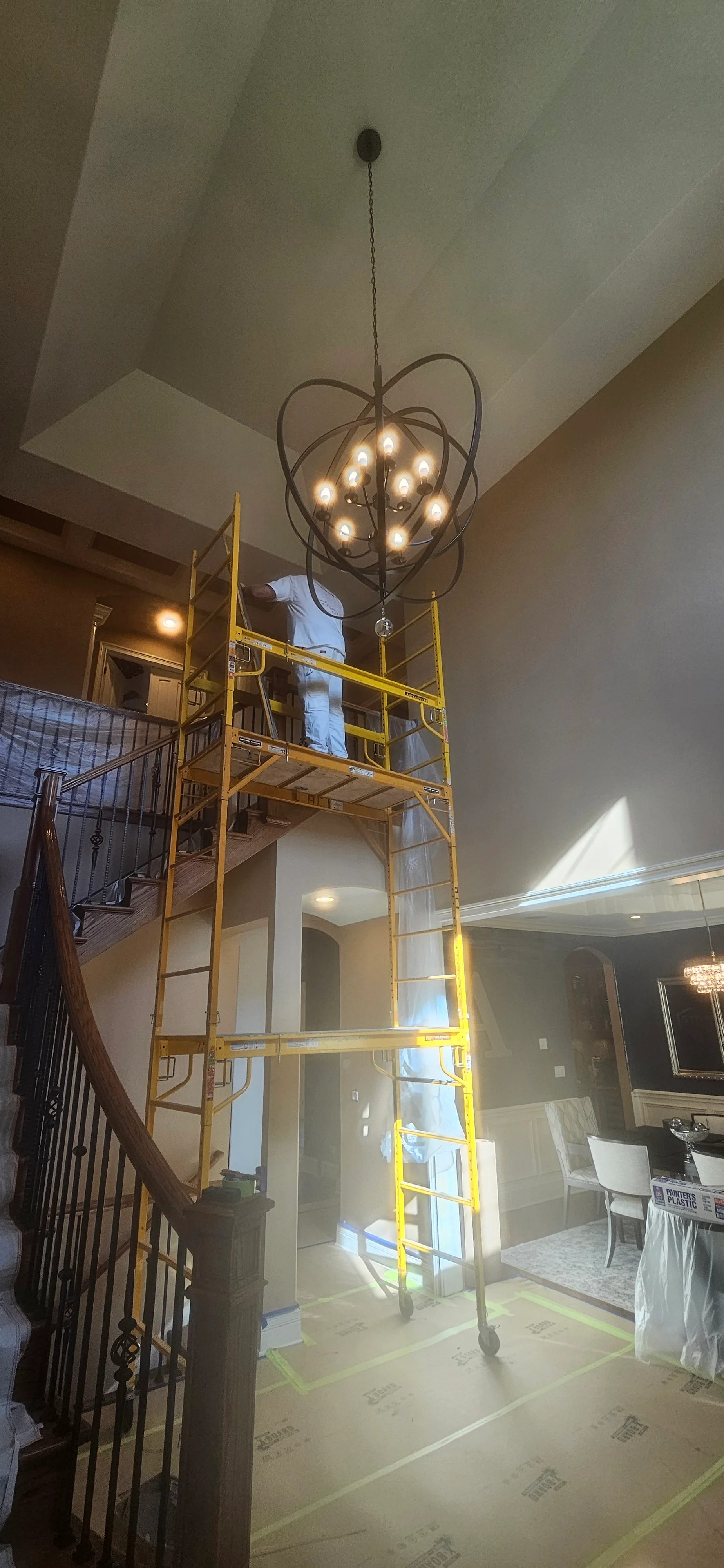Two-story foyer with freshly painted drywall ceiling and walls, neutral finish with recessed lighting