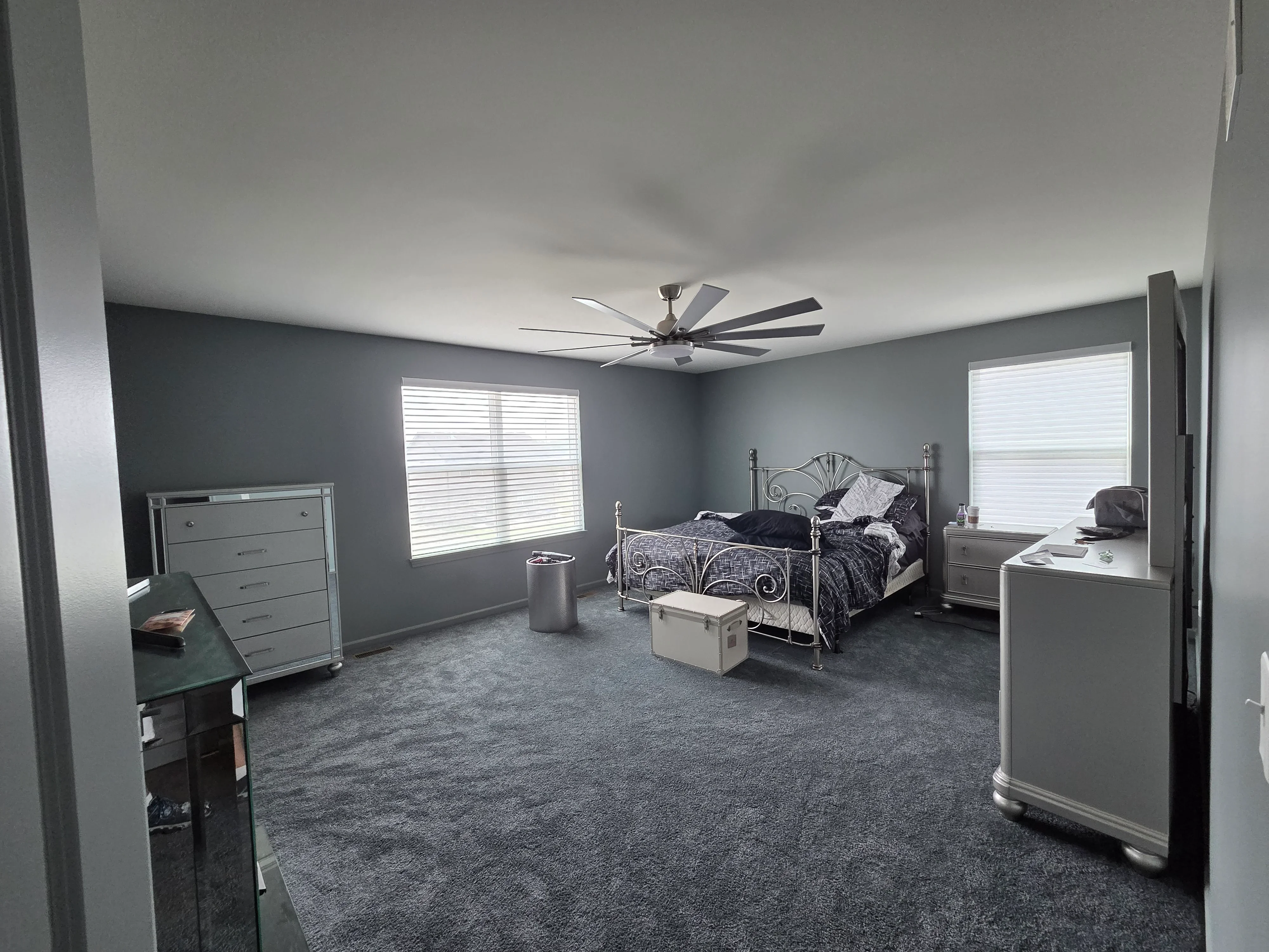 Gray painted bedroom walls with white ceiling, trim, and ceiling fan installation