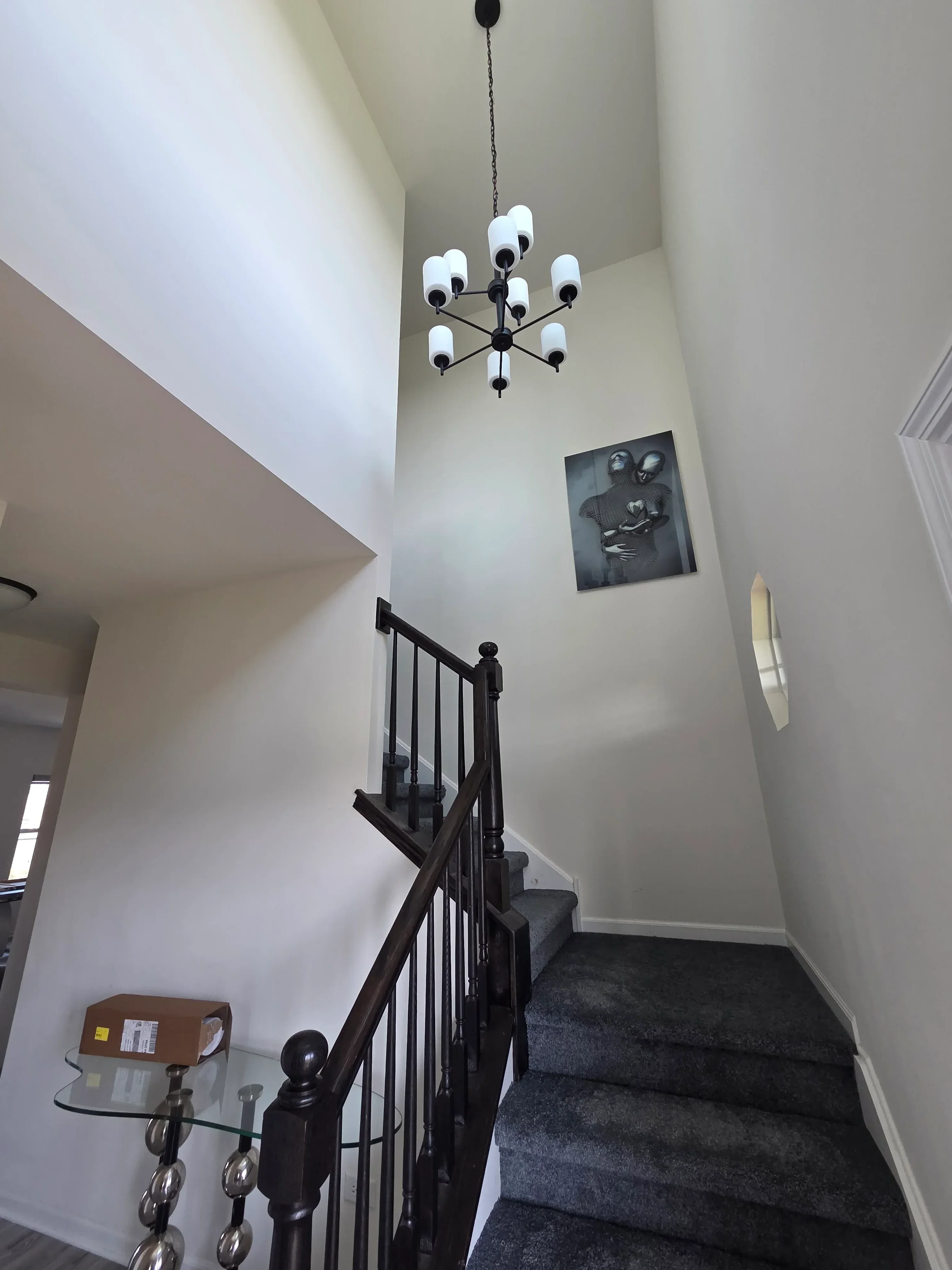 White painted bedroom walls and ceiling with crown molding, recessed lighting, and black metal bed frame