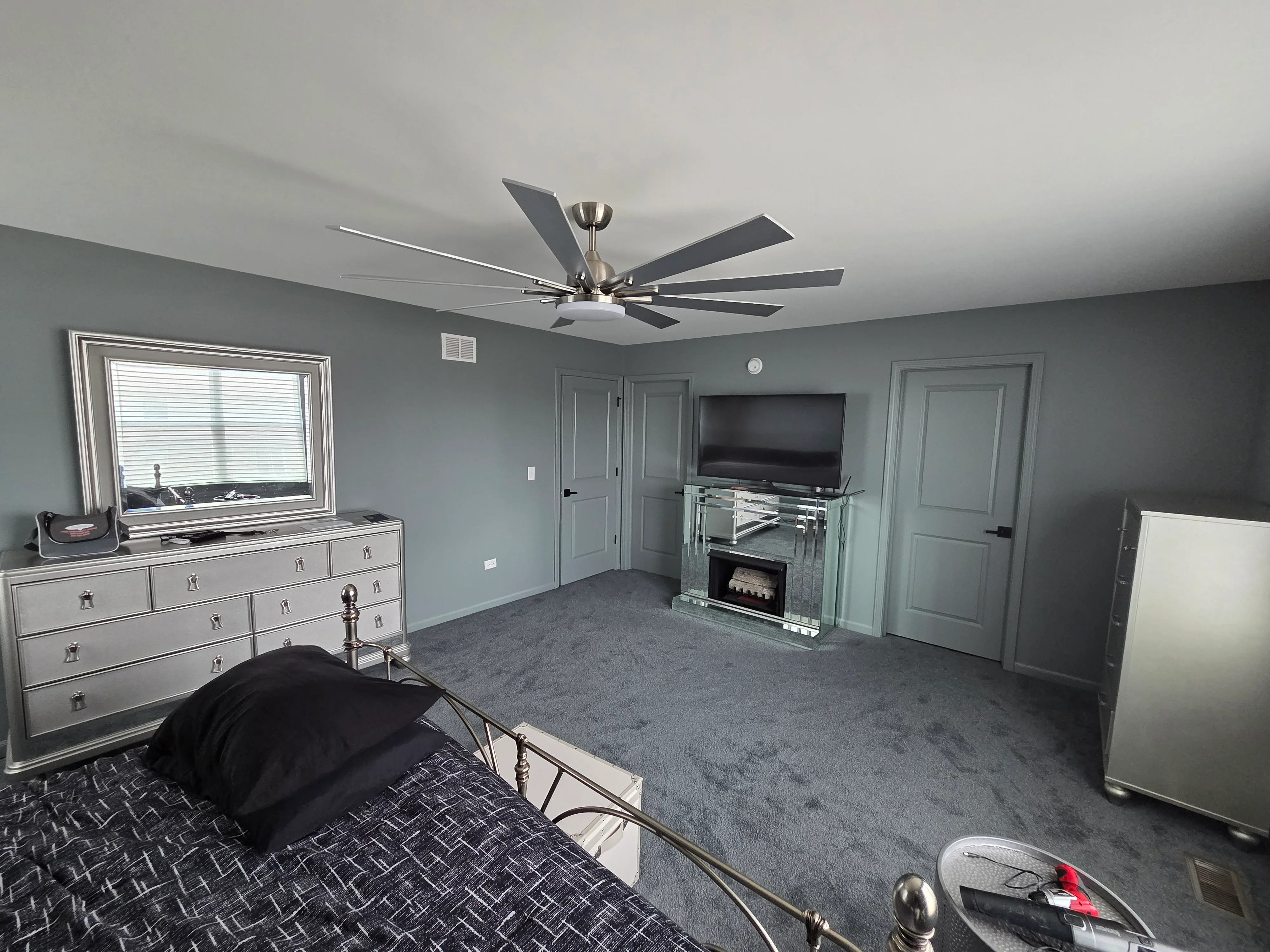Gray painted bedroom walls with white trim, doors, and ceiling in finished interior space